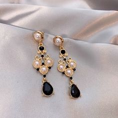 Beautiful vintage style black onyx and pearl lace dangle earrings. Delicate fan shape gold lace with pearls embedded, teardrop black gemstone dangle. Dark Gothic accent yet looks elegant and glamorous. Handmade dainty and sturdy earrings, gorgeous ear statement jewelry for parties and occasions and weddings. 💎 Features: ♥ Finish: 14K Gold plated, 925 sterling silver post ♥ Main Stone: black onyx zircon ♥ Side Stone: baroque pearl ♥ Push back closure ♥ Approximate Measurements: - Length: 2.7" - Black Pearl Drop Earrings For Formal Events, Black Pearl Drop Earrings For Formal Occasions, Black Pearl Drop Earrings For Evening, Black Dangle Pearl Earrings, Vintage Black Earrings For Wedding, Black Pearl Earrings For Formal Occasions, Elegant Black Bead Drop Earrings, Elegant Teardrop Black Bead Jewelry, Elegant Black Pearl Drop Earrings