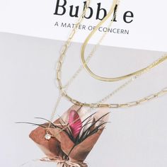 Experience luxury with our Layered Gold Necklaces set for women. This 3-piece 14K Vermeil Gold/Silver set includes a 16-inch clavicle herringbone necklace, a 17-inch paperclip style necklace, and an 18-inch necklace with a 1 carat total weight of flawless princess cut cubic zirconia pendant. These versatile pieces can be worn together as a layered style or separately to complement any outfit. Perfect for any occasion, this set makes a stunning gift for someone special. Don't miss out on the chan Layered Gold Necklaces, Necklaces Set, Layered Style, Herringbone Necklace, Gold Necklace Set, Gold Necklaces, Gold Necklace Layered, Style Necklace, Set For Women