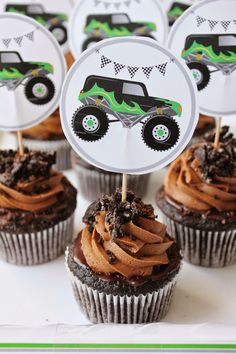 cupcakes with dirt trucks on them are sitting on a plate in front of other cupcakes