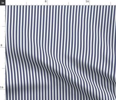 a blue and white striped shirting fabric with a ruler in front of the image