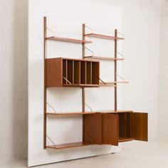 a book shelf that is made out of wood and has several compartments on each side