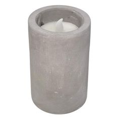 a concrete candle holder with a single white candle in the center, on a white background