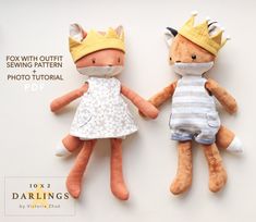 two stuffed animals with crowns on their heads and one is wearing a dress, while the other has a crown