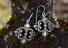 Handmade bronze or sterling silver earrings with ancient royalty symbol Fleur-De-Lis. Bronze earrings have sterling silver 925 hooks. If you would like to order the same design earrings, made from gold-plated silver, please, contact us and we will make them specially for you! The fleur-de-lys symbol is considered a symbol of French royalty. The history of this symbol has begun already in the 12th century. Most likely, in the symbol is pictured stylized lilies or lotus flowers, however, some hist Ancient Royalty, Lily Earrings, Wild Iris, French Royalty, Luxury Gifts For Her, Bronze Earrings, Lotus Flowers, Design Earrings, 12th Century