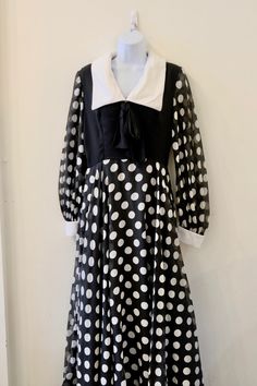 "1970's Vintage Black and White Polka Dot Cotton Maxi Gown Dress with White Collar and Cuffs Black Bodice with Bow and Full Length Lined Sheer Skirt - Polkadot Cotton Sheer Overlay on Black Cotton Lining Colors on Black Big Polka Dots Very Graphic Dress Brunch on Sunday Dress Outside Concert in the Summer Dress no tag Open Neckline with Sailorish Pointed Cotton Percale Collar 2\" cuff with snap closure fully lined bodice fully lined skirt sleves- sheer Size small 4 - 6 Measurements: (flat) 14\" Vintage Polka Dot Long Sleeve Dresses, Vintage Long Sleeve Polka Dot Dress, Black Long Sleeve Dress For Vintage Fashion, Vintage Fashion Long Sleeve Black Dress, Black Vintage Dress For Costume Party, Black Vintage Dress For Costume, Retro Long Sleeve Costume Dress, Black Long Sleeve Vintage Dress, Black Retro Dress For Costume Party