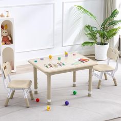 a child's table and chairs with toys on the floor in front of it