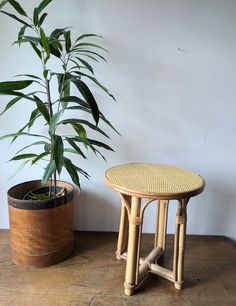 a small round table next to a potted plant