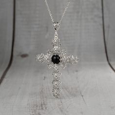 925 Sterling Silver Filigree Art Black Onyx Cross Pendant Necklace Pendant height: 2.30 inches and Width: 1.50 inches Chain Style: 18.00 inches +2.00 inches (extender) This metal embroidery filigree necklace is oxidized and highly polished. Black Onyx Gemstone is 12 mm cabochon round cut Filigree is a unique piece that incorporates handcrafted twisted threads of precious metal into its design. The metal is then soldered to the Silver jewelry and can take the shape of lacy flourishes, beautiful s Elegant Silver Necklace With Cross Pendant, Elegant Silver Cross Pendant Necklace, Black Engraved Cross Jewelry, Formal Black Engraved Necklace, Elegant Onyx Wire Wrapped Necklace, Black Engraved Cross Pendant Necklace, Black Cross Pendant Jewelry Gift, Onyx Necklace With Large Pendant For Gift, Silver Onyx Gothic Necklace