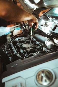 a man working on an engine in his car