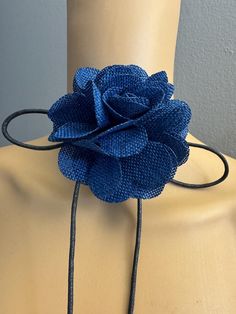 a close up of a mannequin with a blue flower on it's neck