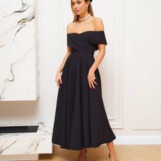 Make an elegant statement with this stunning black off-the-shoulder A-line dress. Perfect for formal events, weddings, or cocktail parties, this chic midi dress combines timeless style with modern sophistication. 🖤 Off-the-Shoulder Design: The off-the-shoulder neckline beautifully frames your shoulders and adds a touch of romance to the look. 👗 A-Line Silhouette: The flattering A-line design creates a graceful and flowy shape, perfect for dancing the night away. ✨ Midi Length: This elegant mid Chic Wedding Guest Dress, Formal Dress Black, Black Formal Dress, Midi Dress Chic, Formal Evening Gown, Cocktail Dress Formal, Elegant Midi Dresses, Black Dress Formal, Black Formal