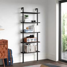 a living room with a book shelf next to a sliding glass door