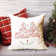 a christmas pillow sitting on top of a white couch