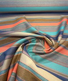 a multicolored striped fabric with blue, orange and brown stripes on it's surface