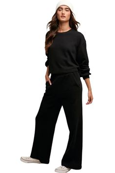 Elevate your loungewear game with our Knit Sweat Top and Wide Leg Pants Athleisure Lounge Set. The cozy knit sweat top features a classic round neck and long sleeves for a relaxed fit, while the wide-leg long pants offer comfort and style. The elastic waist ensures a customizable fit, and the inclusion of pockets on the pants adds a practical touch to the ensemble. - Model is 5' 10" 32-26-35 and wearing a size MediumMeasurement from a Small:Pants Inseam: 27"Top Length: 19.5"import Style: Casual Fall Solid Activewear For Lounging, Solid Activewear For Lounging In Fall, Fall Lounging Solid Activewear, Fall Lounging Activewear, Relaxed Fit Sweatshirt For Loungewear, Athleisure Sweats For Elevated Casual Fall Wear, Oversized Sweats With Elastic Waistband For Fall, Relaxed Sweats With Ribbed Cuffs For Leisure, Fall Long Sleeve Sweats With Elastic Waistband