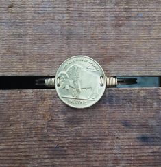 A brass cuff featuring a vintage brass Buffalo Nickel stamping.Details:-Cuff is adjustable and made of brass-Brass Buffalo Nickel stamping is vintage; it has been clear-coated to prevent tarnish-Stamping measures 1 inch in diameter-Stamping is wire-wrapped onto the cuff Adjustable Antique Gold Metal Cuff Bracelet, Adjustable Bronze Cuff Bracelet With Antique Finish, Nickel-free Adjustable Brass Bracelets, Adjustable Stamped Gold Cuff Bracelet, Adjustable Nickel-free Brass Bracelets, Gold Adjustable Stamped Cuff Bracelet, Adjustable Gold Stamped Cuff Bracelet, Nickel-free Brass Bracelets, Nickel-free Bronze Brass Bracelets