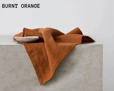 an orange cloth sitting on top of a cement block