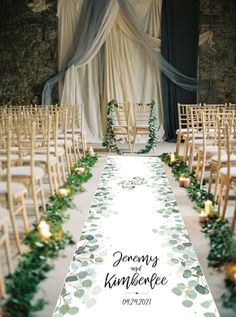 the aisle is lined with candles and greenery for an elegant ceremony at this venue