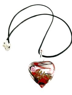 The clear heart has pink flowers on the glass with red and black ribbon swirls in the glass. It creates a neat glass pendant necklace The necklaces is a great statement piece. Glass heart pendant is 1 1/4” wide and hangs 1 1/2” from the cord Black cord is 18” La Jewelry, Clear Heart, Glass Pendant Necklace, Glass Heart, Black Ribbon, Glass Necklace, Glass Pendant, Pink Flower, Red And Black