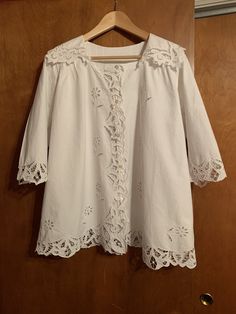 Gorgeous Edwardian lace blouse with beautiful details at the collar and hems. In pristine condition, no blemishes. This was probably never worn. Authentic antique made circa 1910 with shell buttons and pleated back. Would be perfect for a costume for someone wanting a seriously authentic look. Fits like womens size 10 22 inches across the bust, 23 inches from neck to bottom of blouse, 15 inches from shoulder to end of sleeve. Classic Wedding Blouse With Buttons, Broderie Anglaise Lace Top For Daywear, Victorian Lace Collar Blouse For Spring, Elegant Broderie Anglaise Lace Top With Short Sleeves, Victorian Blouse With Lace Collar For Spring, Victorian Lace Trim Top For Daywear, Elegant Short Sleeve Lace Top With Broderie Anglaise, Classic Formal Blouse With Lace Trim, Vintage White Tops With Lace Trim For Daywear