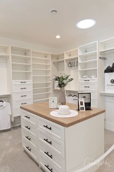 a kitchen with white cabinets and counter tops