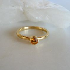 Elegant 14K Gold Ring with 4mm Bezel Set Citrine - November Birthstone Jewelry, size 7 Add a touch of sophistication to your jewelry collection with this stunning 14K gold ring featuring a 4mm bezel set citrine. Perfect as a November birthstone gift or a timeless piece for any occasion, this ring showcases both elegance and craftsmanship. Specifications: Weight: 1.78 DWT (2.77 grams) Primary Stone Count: 1 stone Stone Type: Citrine Stone Setting: Bezel Material: 14K Yellow Gold Ring Fit: Standar Gold Oval Birthstone Stackable Ring, Gold Oval Stackable Birthstone Ring, Gold Birthstone Ring With Round Band For Everyday, Everyday Gold Birthstone Ring With Round Band, Everyday Gold Stackable Sapphire Ring, Amber Topaz Birthstone Ring For Anniversary, Gold Rings With Smooth Bezel And Round Stone, Stackable Yellow Gold Rings With Round Stones, Amber Topaz Promise Ring