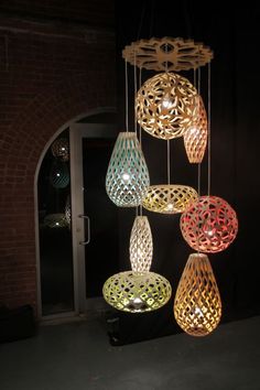 a group of lights hanging from the ceiling in front of a door at night time