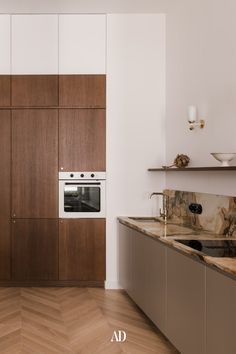 a modern kitchen with wooden cabinets and marble counter tops, along with stainless steel appliances