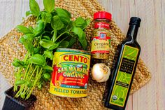 herbs, spices and seasoning on a placemat next to a bottle of olive oil