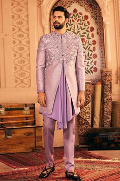 Lilac hand embroidered sherwani featuring sequin, moti work and french knots in a geometric pattern crafted in raw silk fabric. Paired with draped kurta and pant.
Components: 3
Pattern: Embroidered
Type Of Work: Thread
Neckline: Band collar
Sleeve Type: Long
Fabric: Raw Silk, Satin
Color: Purple
Other Details: 
Approx. product weight: 2.2 kgs
Occasion: Mehendi and Puja - Aza Fashions Semi-stitched Silk Sherwani For Designer Wear, Designer Semi-stitched Silk Sherwani, Silk Sherwani With Embroidery For Reception, Designer Silk Sherwani With Traditional Drape, Transitional Silk Sherwani With Dabka Work, Long Sleeve Silk Sherwani For Reception, Formal Raw Silk Kurta With Mirror Work, Semi-stitched Silk Sherwani With Resham Embroidery, Silk Sherwani With Zari Work And Traditional Drape