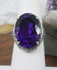 Natural Purple Amethyst Ring Persian Design#230 Custom Made This is a brand new stunning Art Nouveau/Vintage designed sterling silver filigree 10.54ct oval Natural Purple Amethyst ring. The Flawless oval full cut high-quality Amethyst is 18mm (just shy of 3/4th of an inch) by 13mm (1/2 inch) in dimension... This ring is 21mm North South on the finger. The inside of the band is marked 925 for sterling. Notice the beautiful filigree swirl like the craftsmanship of the silver setting. This lovely r Oval Amethyst Collectible Ring, Victorian Style Oval Purple Amethyst Ring, Classic Large Stone Amethyst Ring For Formal Events, Ornate Oval Amethyst Ring, Classic Oval Purple Gemstones, Oval Amethyst Filigree Ring For Wedding, Oval Amethyst Ring With Filigree Detail, Purple Oval Filigree Rings, Oval Amethyst Ring With Intricate Design