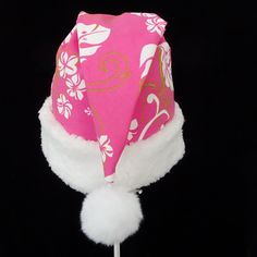 "This novelty tropical Santa hat is made up in a pink Hawaiian floral print cotton fabric. Island style fabric hat is decorated with a snowy white faux Sherpa fur fabric trim. Put Santa in a tropical island mode for that balmy warm holiday season or for a Christmas in July celebration. The sizing on the hat is generous and will fit most adult and teen head sizes. The styling is a slouch cone, traditional Santa look. There is a snowy white pompom stitched on the top. Opening measurement is 24-25\ Pink Cotton Cap Sun Hat, Pink Cotton Cap-shaped Sun Hat, Pink Cotton Hat Gift, Las Vegas Christmas, Tropical Santa, Hawaiian Floral Print, Santa Costume, Santa Claus Hat, Earring Storage