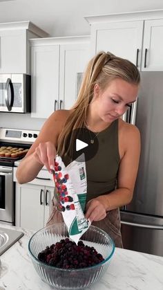 a woman is making cranberry sauce in her kitchen