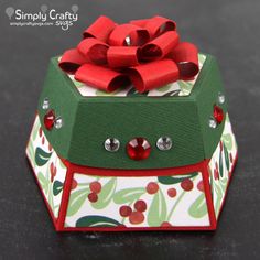 an origami box with a red bow on top