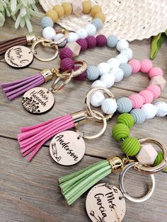 several key chains with different colored tassels on them