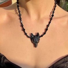 "Embrace your inner mystic with this stunning Wolf Black obsidian Necklace. Crafted in a gothic, boho style, this pendant showcases a powerful obsidian stone, known for its healing properties and spiritual connection. Perfect for the witchy jewelry lover, this unique piece will add a touch of enchantment to any outfit. Let this bewitching necklace be your new go-to accessory. 15-17\" Protection Grief  Truth  Grounding  Can be a gift for loved ones, friends or a treat to yourself.   Comes in a gift bag. PER ORDER you will receive a complimentary crystal that will be chosen intuitively and an oracle card.  Instructions for how to cleanse and charge will also be included. Please note that due to the fact these are natural stones, the colours may vary but will be equally as beautiful. Feel fre Witchy Black Choker For Gift, Bohemian Black Necklace For Halloween, Spiritual Necklaces For Halloween Festival, Gothic Onyx Necklace As A Gift, Gothic Onyx Necklace Gift, Spiritual Halloween Festival Necklaces, Spiritual Necklace For Halloween Festival, Mystical Necklaces For Halloween, Mystical Black Necklace For Gift