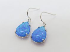 Vintage Sterling Silver Pear cut Blue Opal Dangle Earrings...Marked 925...Total of weights 3.5grams...Measure H 1 2/8'' W 1/2''...These are in very good condition. Blue Sterling Silver Teardrop Earrings, Blue Sterling Silver Teardrop Pierced Earrings, Blue Dangle Jewelry With Hallmark, Blue Sterling Silver Teardrop Earrings Nickel Free, Blue Hallmarked Dangle Jewelry, Blue Pear-shaped Earrings For Gift, Blue Hypoallergenic Sterling Silver Teardrop Earrings, Blue Hallmarked Dangle Earrings, Blue Hallmarked Drop Earrings