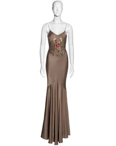 For Sale on 1stDibs - ▪ John Galliano bias-cut evening dress ▪ Taupe crepe-backed satin ▪ Floral embroidery at the front and back ▪ Floor-length skirt with train ▪ Silk trim Embellished Satin Gown For Gala, Embellished Satin Evening Gown, Embellished Satin Evening Dress, Embellished Fitted Satin Gown, Fitted Embellished Satin Gown, Fitted Embellished Satin Evening Dress, Embroidered Satin Evening Dresses, Embroidered Satin Party Gown, Elegant Embroidered Satin Dress