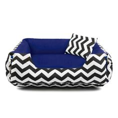 a black and white chevroned dog bed with blue trimmings on it