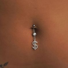 a close up of a person's belly with a piercing on it