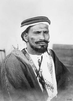 an old black and white photo of a man wearing a turban