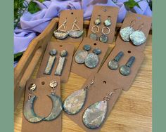 six pairs of earrings are sitting on a table