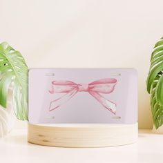 Design: Pink Coquette Aesthetic Pink Bow License Plate  Details: - Each plate is 100% made with robust aluminum material and comes with pre-drilled holes for hassle-free installation.  - Material: 100% aluminum - One size: 12" × 6" (30.5 × 15.2 cm)  - 4 holes for attachment - The product does not come with mounting hardware - Assembled in the USA from globally sourced parts Returns: All products are made to order, therefore returns, refunds, and exchanges are not accepted unless item arrives mis Pink Coquette Aesthetic, Coquette Aesthetic Pink, Front License Plate, Pink Coquette, Cute Car Accessories, Car Accessory, Aesthetic Pink, License Plates, Cute Cars