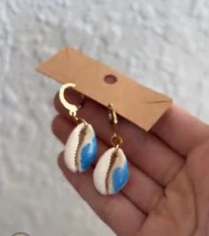 These shell earrings are an amazing beachy girl staple with its hand painted wave on a beachy cowri shell! Please keep in mind these can tarnish is worn in water so I would avoid it if possible! BOUGHT AND LOVE IT? Please write a review as it helps customers feel satiated purchasing!💓 Trendy Shell Jewelry For Beach, Trendy Shell Jewelry For The Beach, Handmade Summer Earrings For Beach Season, Trendy Shell-shaped Jewelry Gift, Handmade Blue Summer Jewelry, Handmade Summer Blue Jewelry, Shell-shaped Beach Jewelry With Ear Wire, Ocean-inspired Shell Earrings As Gift, Handmade Beachy Earrings For Beach Season