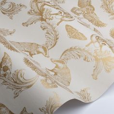 the wallpaper is gold and white with an animal pattern on it's side