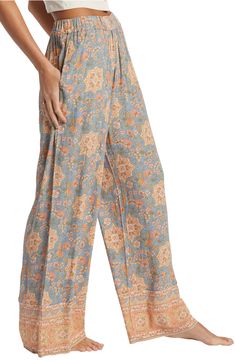 Feel the breeze in these flowy crinkle-textured pants covered in a lively print with contrasting borders. 28" inseam Elastic waist Side-seam pockets 100% viscose Machine wash, tumble dry Imported Vacation Rayon Printed Pants, Vacation Printed Rayon Pants, Printed Rayon Wide-leg Pants, Printed Rayon Bottoms For Vacation, Printed Wide-leg Rayon Bottoms, Vacation Rayon Pants With Floral Print, Patterned Wide Leg Bottoms With Pockets, Printed Rayon Beach Bottoms, Rayon Floral Print Pants For Vacation