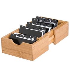 a wooden drawer with several files in it