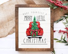 a wooden sign with a christmas tree in the back and merry little christmas written on it