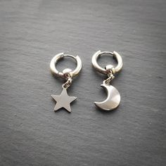 Mismatched moon and star huggie hoop earrings in silver! Unisex Earrings are made of 100% stainless Steel so are hypoallergenic and won't tarnish or discolour. You will receive one moon earring and one star earring, if you would like a different combination please contact me. Hoops measure 15mm Please don't hesitate to contact me with any queries or suggestions ☺️  Cones gift wrapped 🖤 Mens Earring, Star And Moon Earrings, Earrings Mens, Moon Earring, Star Earring, Womens Jewellery, Punk Earrings, Unisex Earrings, Star And Moon