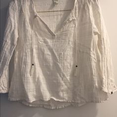 a white shirt hanging up on a wall